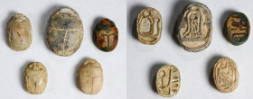 Group of Five Egyptian Glazed Steatite Scarabs. New Kingdom, ca. 1550-1069 B.C. Average Grade: FINE.
Comprising a cartouche flanked by uraei with hea...