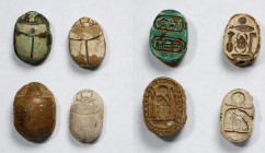 Group of Four Egyptian Glazed Steatite Scarabs. ca. 1650-924 B.C. Average Grade: VERY FINE.
Comprising a large brown glazed scarab with hieroglyphs i...