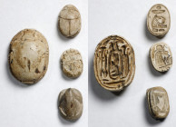 Group of Four Egyptian Stone Scarabs. New Kingdom, ca. 1550-1069 B.C. Average Grade: FINE.
Consisting of a large pale green glazed steatite scarab fe...