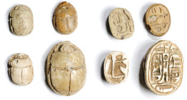 Group of Four Egyptian Glazed Steatite Scarabs. ca. 1550-924 B.C. Average Grade: FINE.
Comprising a large, beige glazed scarab bearing two cartouches...