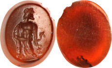 Roman Dark Red Carnelian Intaglio. ca. 2nd Century A.D. 0.50 gms. VERY FINE.
Dimensions: 11 x 9mm. Incised with a figure of bearded Aesculapius, stan...
