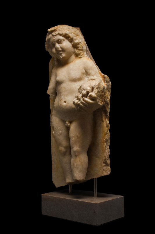 LARGE ROMAN MARBLE FIGURE OF CUPID HOLDING GRAPES- EX R.SORGE COLLECTION
Ca. 20...
