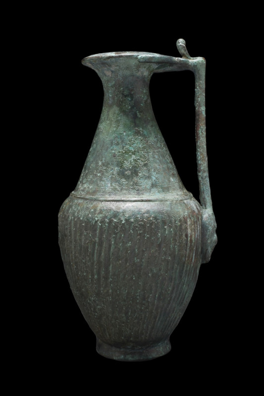 LARGE ANCIENT ROMAN BRONZE OLPE
Ca. 300-400 AD. 
A bronze jug with a flaring s...