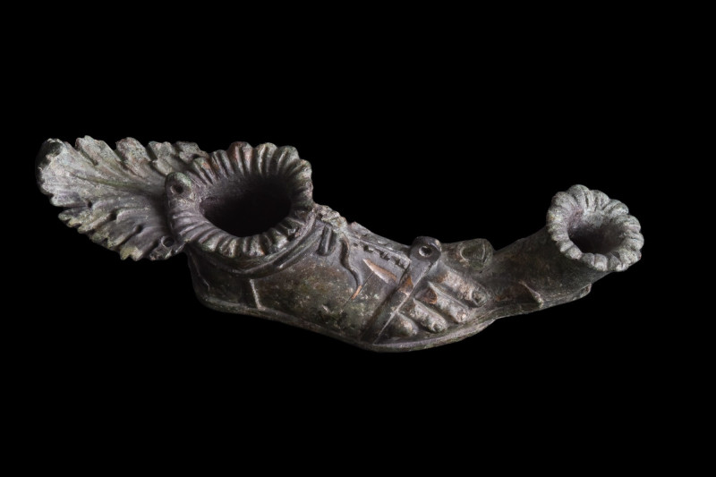 ROMAN BRONZE FOOT IN A SANDAL OIL LAMP
Ca. 100-200 AD. 
A beautiful cast-bronz...