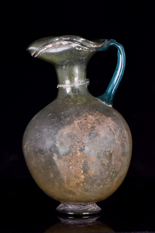 ROMAN GLASS JUG WITH TREFOIL RIM
Ca. 200–300 AD. 
A blue-green, free-blown gla...
