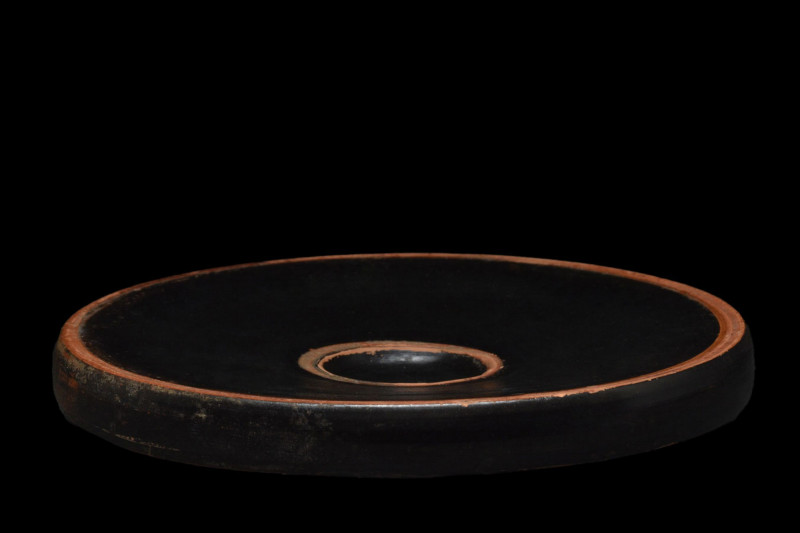 ATTIC BLACKWARE FOOD PLATE
Ca. 400-300 BC. 
A black-glazed pottery fishplate, ...