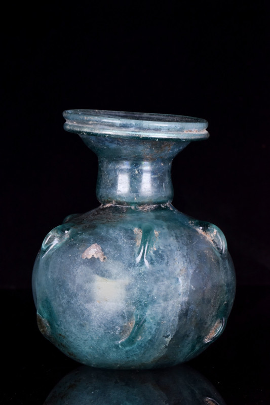 AQUAMARINE ROMAN PINCHED GLASS FLASK
Ca. 100–200 AD. 
A free-blown sprinkler f...