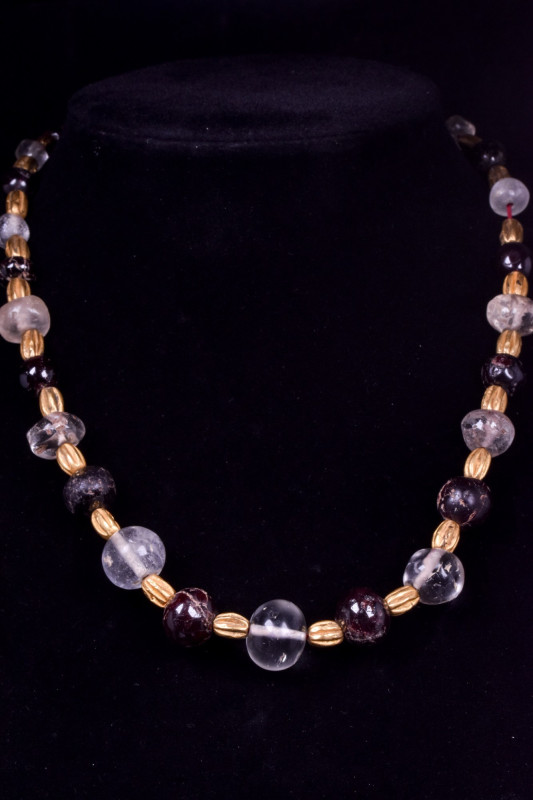 HELLENISTIC CRYSTAL, GARNET, AND GOLD NECKLACE
Hellenistic, Ca. 300-200 BC. 
H...