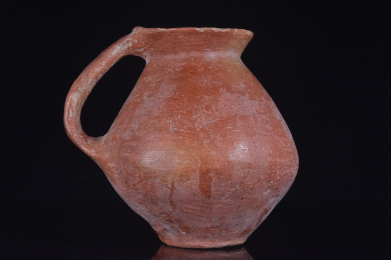 HOLY LAND BURNISHED JUG
Ca. 3rd Millennium BC. 
A Holy Land jug set on a low r...