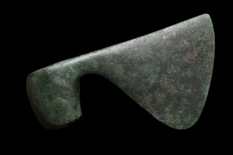 BRONZE AGE BRONZE AXE HEAD
Ca. 1500-1000 BC. 
A cast bronze war axe head featu...