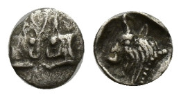 CARIA. Uncertain mint (Circa 450-400 BC). AR Tetartemorion. (6mm, 0.07 g) Obv: Foreparts of two confronted bulls, with horns intertwined Rev: Bull hea...