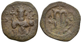 Arab-Byzantine, Umayyad Caliphate. Pre-reform. AH 41-77 / AD 661-697. Æ Fals (21mm, 3.14 g). Pseudo-Byzantine Imitating Constans II. Standing figure o...