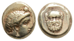 Greek, Lesbos. Mytilene 375-325 BC. Hekte EL10,3 mm., 2,5 g.
Head of Dionysos right, wearing ivy-wreath / Mask of Silenos facing, within linear squar...