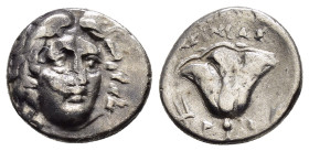 CARIA.Rhodes.(229-205 BC).Drachm.

Obv : Head of Helios facing slightly right.

Rev : Rose, bud to right, tripod to left.

Weight : 2.6 gr
Diameter : ...