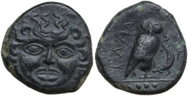 Sicily. Kamarina. AE Tetras or Trionkion, c. 420-410 BC. Obv. Gorgoneion facing. Rev. Owl standing right, head facing, clutching lizard in talons; bel...