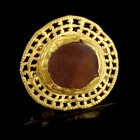 Roman Gold Medaillon
1st-3rd century CE
Gold, Carnelian, 26 mm, 5,15 g
Openwork gold disk with a carved carnelian stone in the center bezel. Four s...