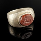 Roman Intaglio Ring 
1st-3rd century CE
Silver, Red Jasper, 21 mm; 17 mm internal dm
Intact and wearable. Intaglio showing Eros riding on a Dolphin...