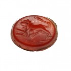 Roman Glas Intaglio
1st-3rd century CE
Red Carnelian, 11 mm
Engraving showing an attacking lion to the right.
Very fine conditon. Remains of rust....