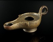 Roman Oil Lamp
2nd-5th century CE
Bronze, 89 mm
Decorated at the side and on the stand.
Very fine condition. Old repair underneath the spout.
Ex....
