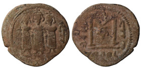 Umayyad Caliphate. 661-680. Fals (3.69 g, 23 mm), Tabariyya (Tiberias). Three standing imperial figures. Rev. Large M; cross above; legend around. Nea...