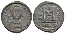 JUSTINIAN I, 527-565 AD. AE, Follis. Nicomedia.
Obv: D N IVSTINIANVS P P AVG.
Helmeted and cuirassed bust facing, holding globus cruciger and shield...
