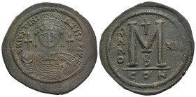 JUSTINIAN I, 527-565 AD. AE, Follis. Constantinople.
Obv: D N IVSTINIANVS P P AVG.
Helmeted and cuirassed bust facing, holding globus cruciger and s...