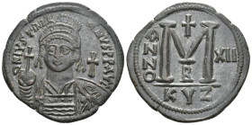 JUSTINIAN I, 527-565 AD. AE, Follis. Cyzicus.
Obv: D N IVSTINIANVS P P AVG.
Helmeted and cuirassed bust facing, holding globus cruciger and shield d...