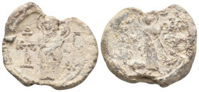 PB Byzantine seal (7th-8th century AD).
Obv: The Virgin standing, holding Christ. On either side, cruciform invocative monograms: Θεοτόκε βοήθει and ...