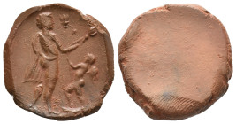 Graeco-Roman clay seal impression (1st-3rd century AD).
Obv: Male figure standing r., holding torch in l. hand; Eros standing l, holding torch to r....