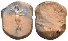 Graeco-Roman clay seal impression (1st-3rd century AD).
Obv: Nemesis (or Nike) standing, right, holding jug with both hands.
Rev: Blank.
Condition:...