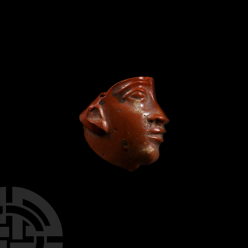 Egyptian Red Glass Face Inlay
Ptolemaic Period, circa 332-32 B.C. A red glass i...