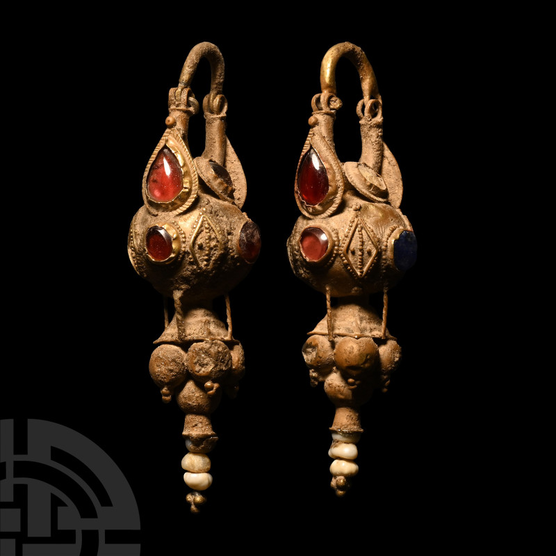 Parthian Gold and Garnet Earrings
2nd-3rd century A.D. A matched pair of gold e...