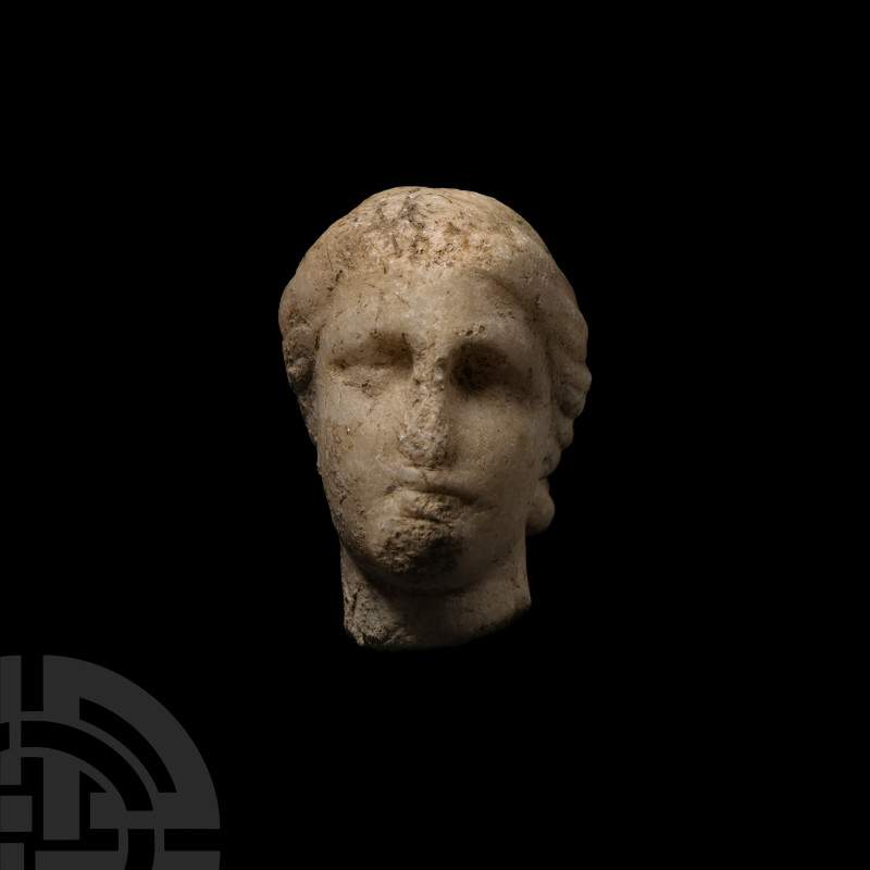 Greek Marble Head of a Female
4th-1st century B.C. A head of a female carved in...