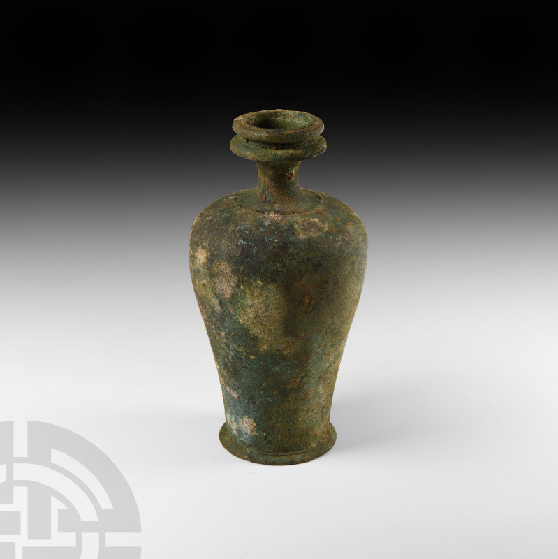 Roman Balsamarium with Spool-Type Mouth
1st-2nd century A.D. A piriform bronze ...