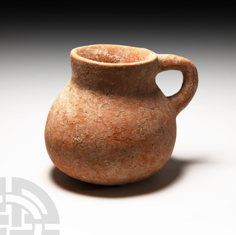 Roman Redware Handled Jug
1st-4th century A.D. A squat coarse terracotta jug wi...