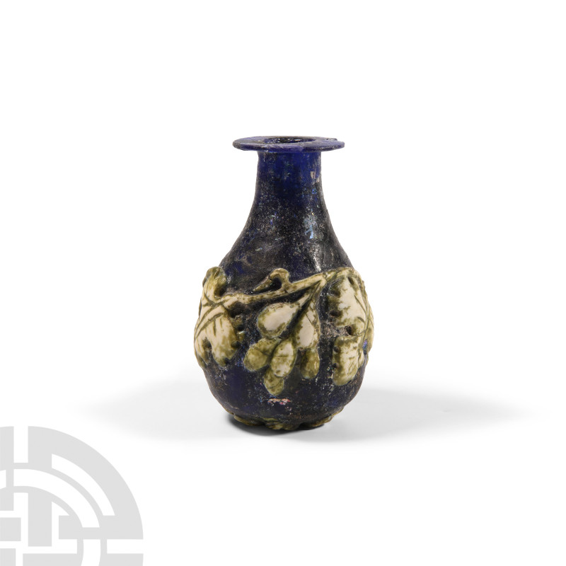 Roman Blue Glass Vessel with Vine Leaf Design
Early 1st century A.D. and later....