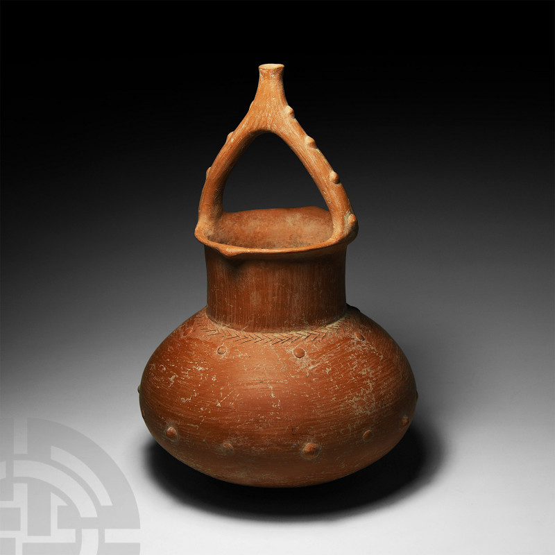 Amlash Handled Jar
1st millennium B.C. An unusual ceramic vessel with carinated...