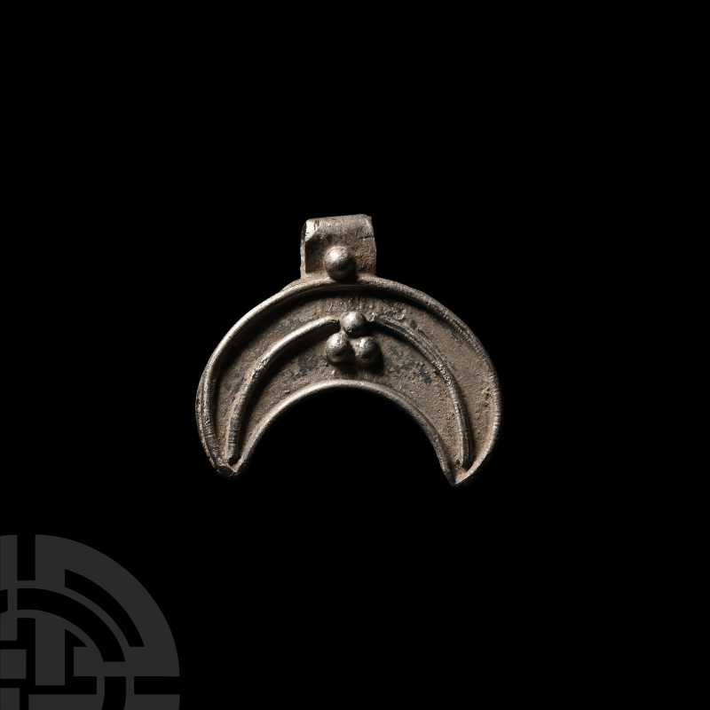 Viking Period Silver Lunar Pendant
Circa 10th century A.D. A silver crescent pe...