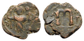 Islamic, Arab-Byzantine, c. 660s-680s. Æ Fals (21mm, 5.13g, 12h), Emperor standing facing, holding long cross and globus cruciger. R/ Cursive M. Cf. A...
