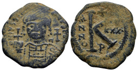 Justinian I 527-565, AE half follis, (26mm, 9.9 g) Antioch Mint (Theoupolis), 557/558 AD Helmeted and cuirassed bust of Justinian I facing, holding gl...