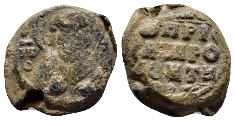 BYZANTINE LEAD SEAL. (17mm, 6.2 g) Obv: Nimbate bust of saint. Rev: Legend in 3 ...