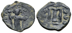 Arab-Byzantine, c. 660s-680s. Æ Fals (22mm, 5.0 g), Emperor standing facing, holding long cross and globus cruciger. R/ Cursive M; cross above; ANNO t...