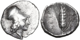 Greek Italy. Southern Lucania, Metapontum. AR Diobol, c. 325-275 BC. Obv. Helmated head of Athena right. Rev. Grain ear with leaf to right; cornucopia...