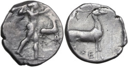 Greek Italy. Bruttium, Kaulonia. AR Stater, c. 475-425 BC. Obv. Apollo advancing right, holding branch; small daimon running on Apollo's left arm; to ...
