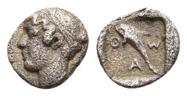 ISLANDS OFF THRACE. Thasos. Hemiobol (Circa 412-404 BC). 

Obv: Diademed head of nymph left.
Rev: ΘAΣ. 
Dolphin left within incuse square.

SNG Locket...