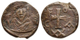 PHOCAS (602-610). Ae Half Follis. Carthage mint. Dated year 6. 

Obv: Crowned bust facing, wearing consular robes and holding mappa.
Rev: Cross potent...
