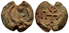 BYZANTINE LEAD SEALS. (22mm, 8.90 g). Obv: Eagle standing facing, head right, with wings spread; star above. Rev: Cruciform monogram.