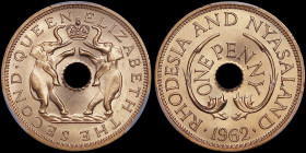 RHODESIA & NAYASALAND: 1 Penny (1962) in bronze. Hole in center and crown flanked by elephants on obverse. Value around hole in center flanked by spri...