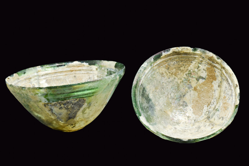 GREEK HELLENISTIC GLASS BOWL
Ca. 200-100 BC. 
A mould-blown green glass bowl w...