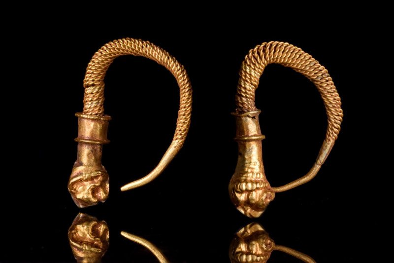 GREEK HELLENISTIC GOLD TWISTED EARRINGS WITH LION HEADS
Ca. 300-100 BC. 
A mat...